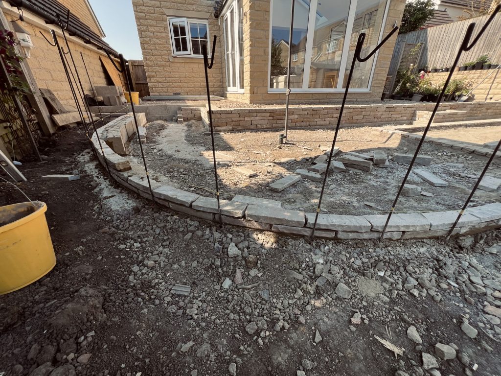 Drystone effect curved sloped wheelchair access path, built in sandstone: Showcasing our bespoke Stonemasonry in Leeds & West Yorkshire.