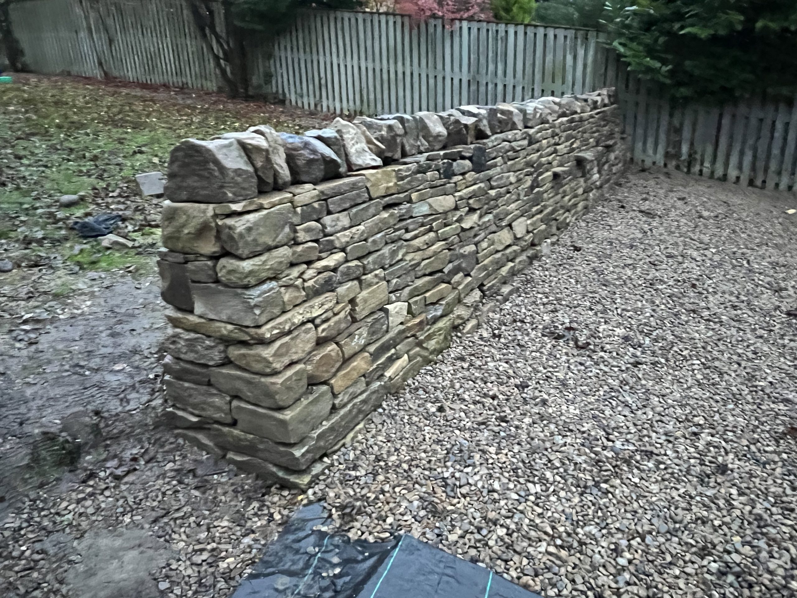 Traditonal Drystone wall with cheek-end and a blob top style topping in Leeds by Strata Stoneworks